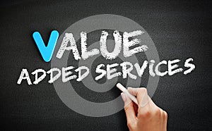 Hand writing Value Added Services on blackboard, concept background