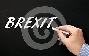 Hand Writing the word Brexit on a Blackboard