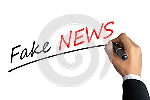 Hand writing word fake news with black color marker pen isolated on white background