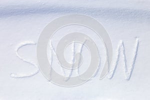 Hand written word `snow` in the snow surface