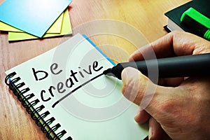 Hand writting title Be creative.