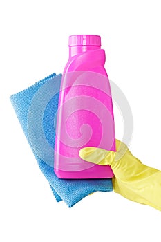 Hand in yellow glove holds pink bottle of liquid detergent and blue rag for duston white background. cleaning