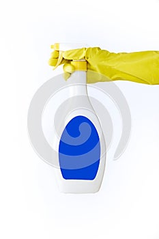 Hand in yellow glove holds spray bottle of liquid detergent on white background. cleaning