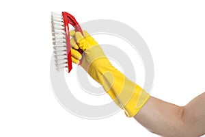 Hand in yellow glove with a red cleaning brush on a white background. Home cleaning concept