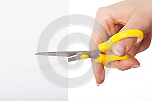 Hand with yellow scissors