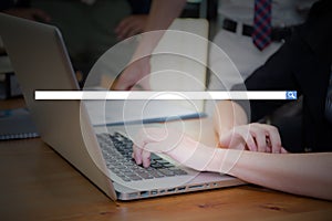 Hand of young business woman typing using laptop computer digital information with blank search bar.