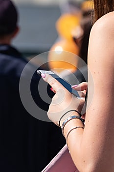 The hand of a young girl holding a phone