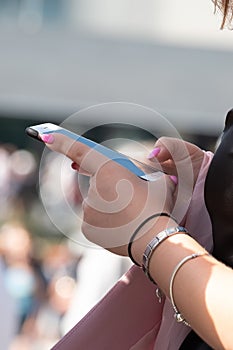 The hand of a young girl holding a phone