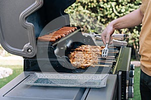Closeup of grilled shashliks and meat skewers on grate.