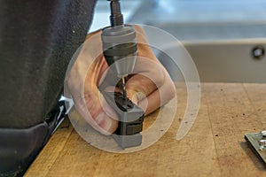 Hand of a young man repair hygrometer with a screwdriver at home