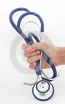 Hand of a young person is holding on a stethoscope isolated