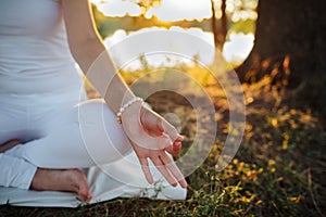 Hand of a young woman are folded in a special way into a yoga m