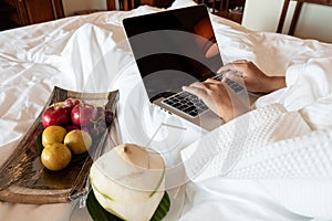 The hand of Young woman Sit play laptop In a luxurious room Ready Fruit