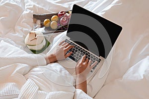The hand of Young woman Sit play laptop In a luxurious room Ready Fruit
