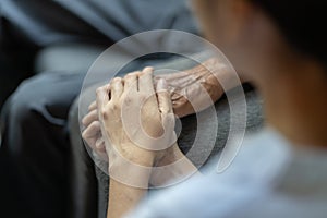 Hand of younger woman holding hand elderly man, helping hands, take care for elderly concept