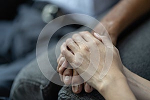 Hand of younger woman holding hand elderly man, helping hands, take care for elderly concept