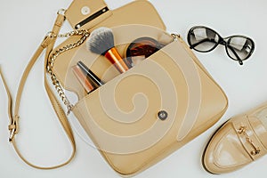 Handbag with cosmetics. sunglasses. shoe. White background.