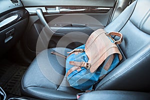 Handbag lying on front passenger seat of car, nobody