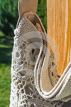 Handbags in sunny outdoor in the garden behind wood and thigh background