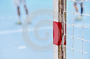 Handball goalpost with players in background photo