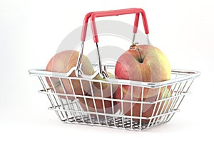 Handbasket with apples on white background