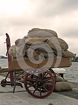 Handcart full of bags in Amsterdam harbor