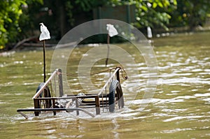 Handcart left at a flooded road