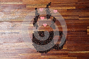Handcrafted arrangement of coffee beans shaped to resemble a heart, symbol of love to commemorate Valentine's Day.