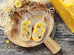 Handcrafted beeswax aromatherapy sachets with dried flowers and beeswax block.