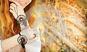 Handcrafted bracelets on a woman hands, dreamcatcher jewelry, close up