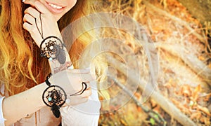 Handcrafted bracelets on a woman hands, dreamcatcher jewelry, close up photo