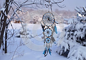 Handcrafted dream catcher with owl decoration and copy space against snow lanscape. photo