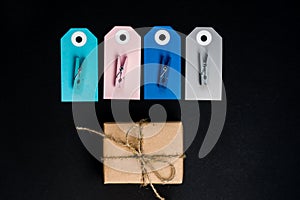 Handcrafted gift boxes wrapped in Craft paper with blue and pink paper card tag, rope and wooden clothespins for decoration