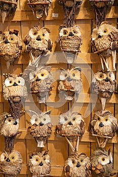 Handcrafted owl toys in a window display photo