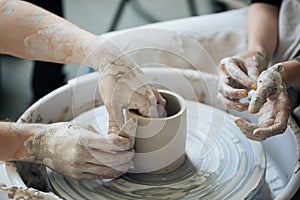 Handcrafted on a potter`s wheel,Hands make clay from various items for home and sale in the store and at the exhibition