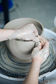 Handcrafted on a potter`s wheel,Hands make clay from various items for home and sale in the store and at the exhibition