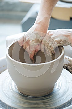 Handcrafted on a potter`s wheel,Hands make clay from various items for home and sale in the store and at the exhibition