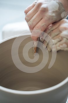 Handcrafted on a potter`s wheel,Hands make clay from various items for home and sale in the store and at the exhibition