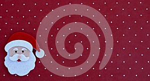 Handcrafted Santa Claus isolated on a red and white background