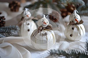 Handcrafted Snowmen Decorations with Carrot Noses and Brown Ribbons on Table