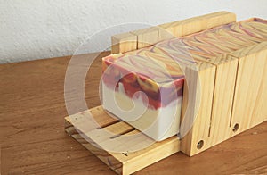 Handcrafted soap block ready to be cut into slices photo