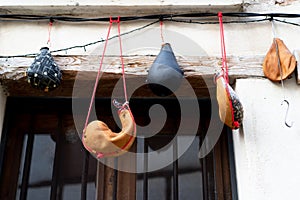 Handcrafted wineskin hanging on the facade of a wineskin shop photo