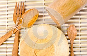 Handcrafted wooden kitchen utensils on bamboo weave