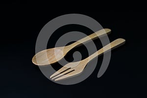 Handcrafted wooden kitchen utensils with a fork and spoon isolated