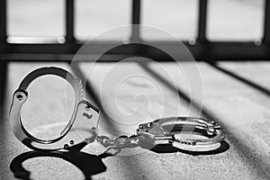 Handcuff and prison bars