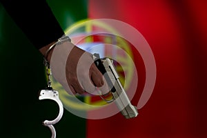 Handcuffed hand in front of the country flag. crime concept