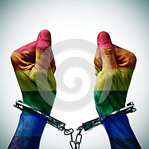 Handcuffed hands denouncing the criminalization of homosexuality photo