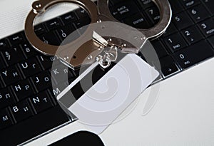 Handcuffs, computer keyboard, credit card