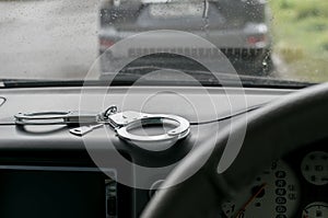 The handcuffs are on the dashboard of the car