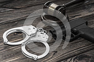 Handcuffs for detaining criminals, a judge`s hammer, photo